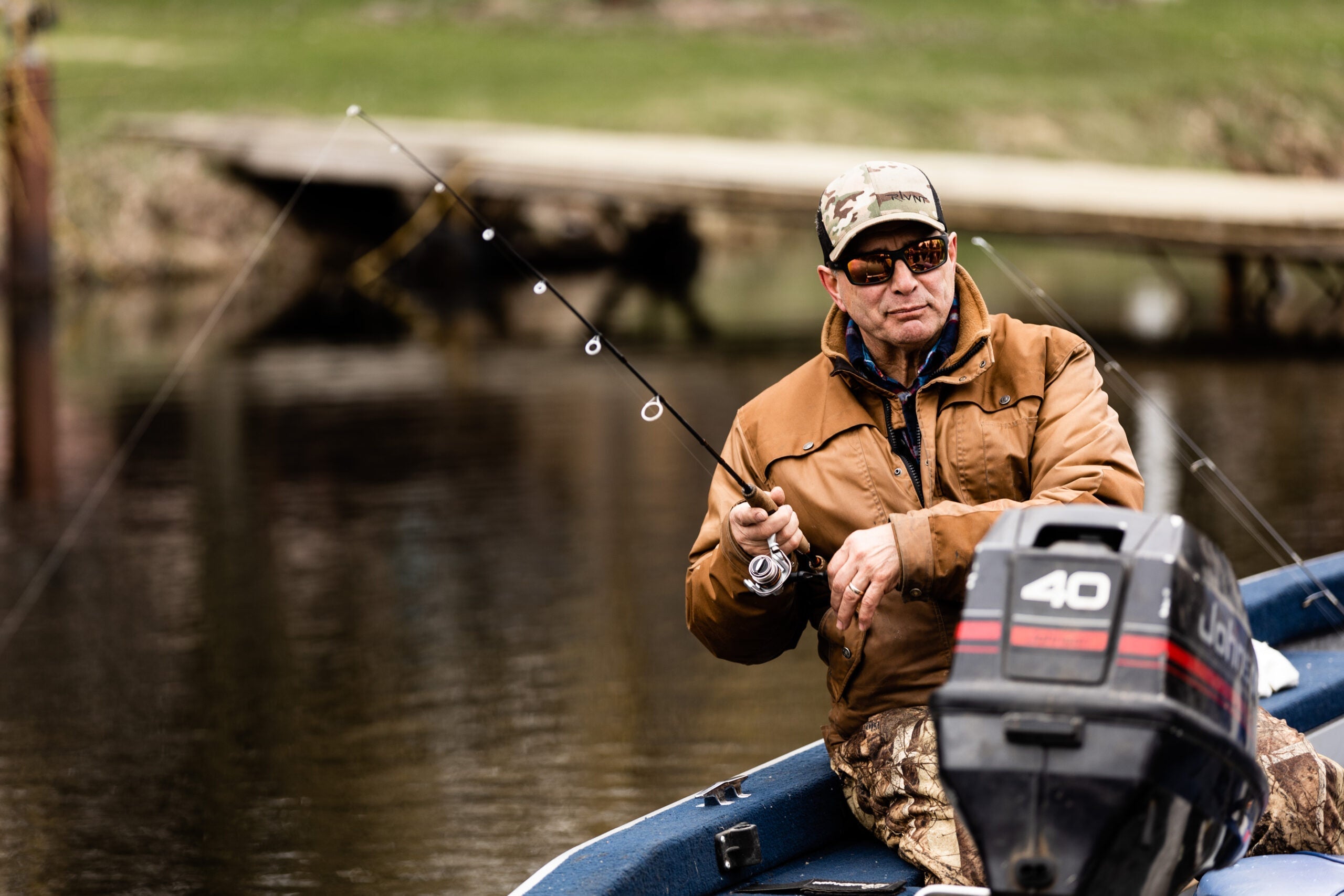 man on boat fishing with RLVNT polarized fishing sunglasses