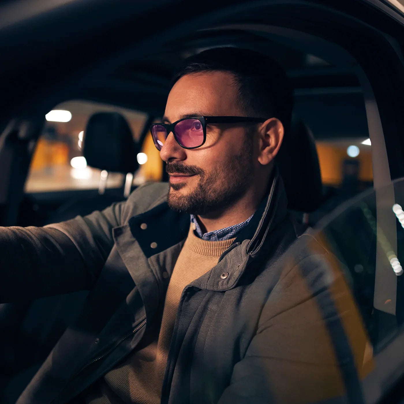 driver wearing purple-toned astigmatism glasses for night driving at dusk